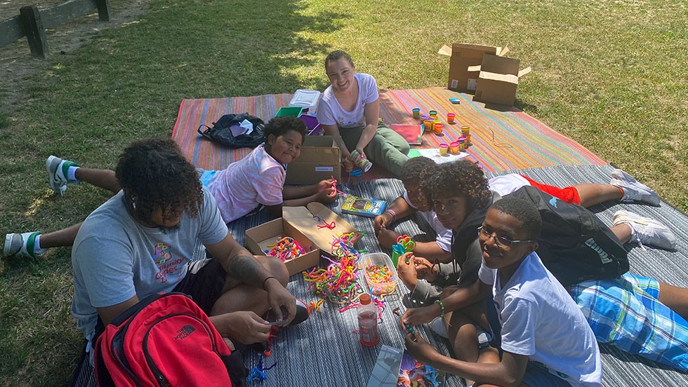 Photo of student with local youth in public park